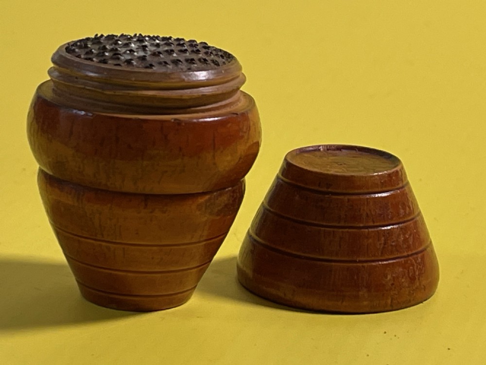 A small turned wooden barrel-shaped antique nutmeg grater with incised line detailing. View III
