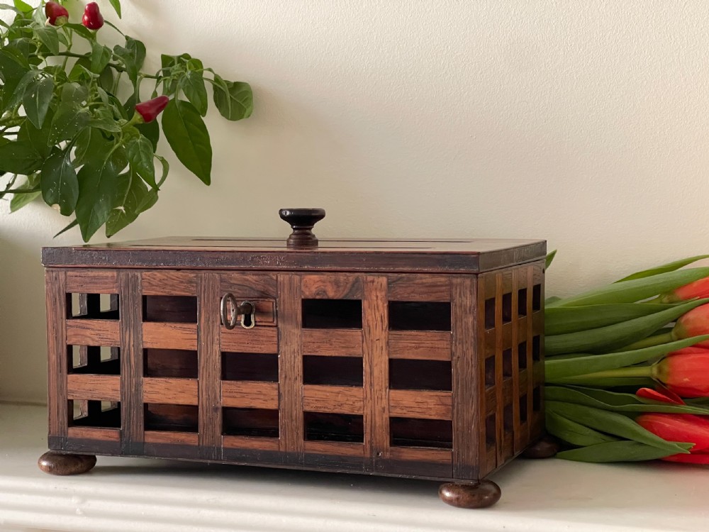 A rectangular antique rosewood stationery box featuring an open lattice exterior, a top lifting knob, bun feet, and an integrated key in the lock. View III