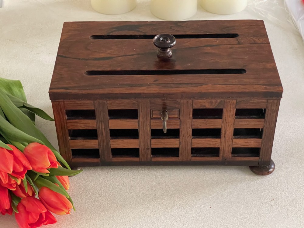 A rectangular antique rosewood stationery box featuring an open lattice exterior, a top lifting knob, bun feet, and an integrated key in the lock. View IV