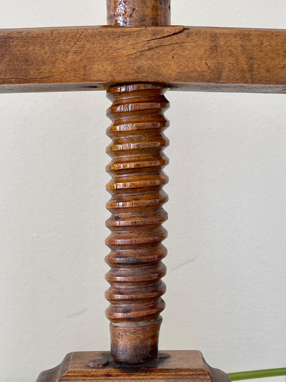 A small antique wooden book and flower press featuring a central threaded screw mechanism and dark brown patina. View III