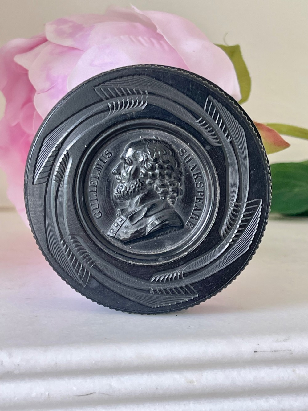 A circular black pressed composition antique snuff box lid depicting a bas-relief profile portrait of George Frederic Handel. View II
