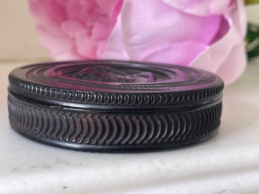 A circular black pressed composition antique snuff box lid depicting a bas-relief profile portrait of George Frederic Handel. View III