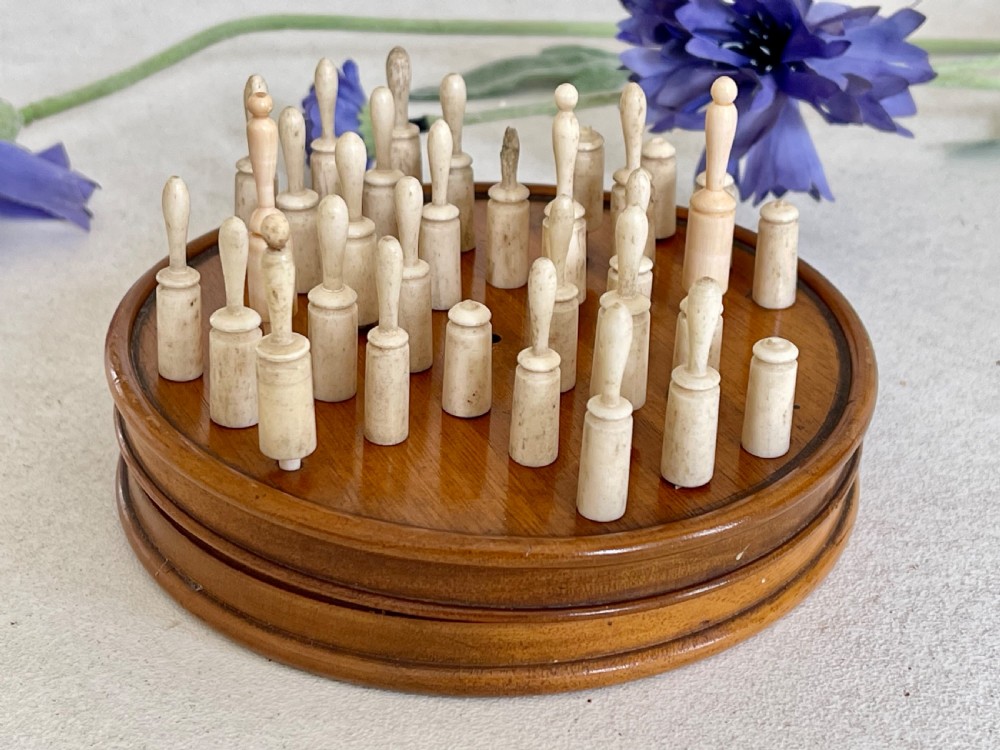 An Antique Treen Travelling Solitaire Game- complete with all its bone pegs View III