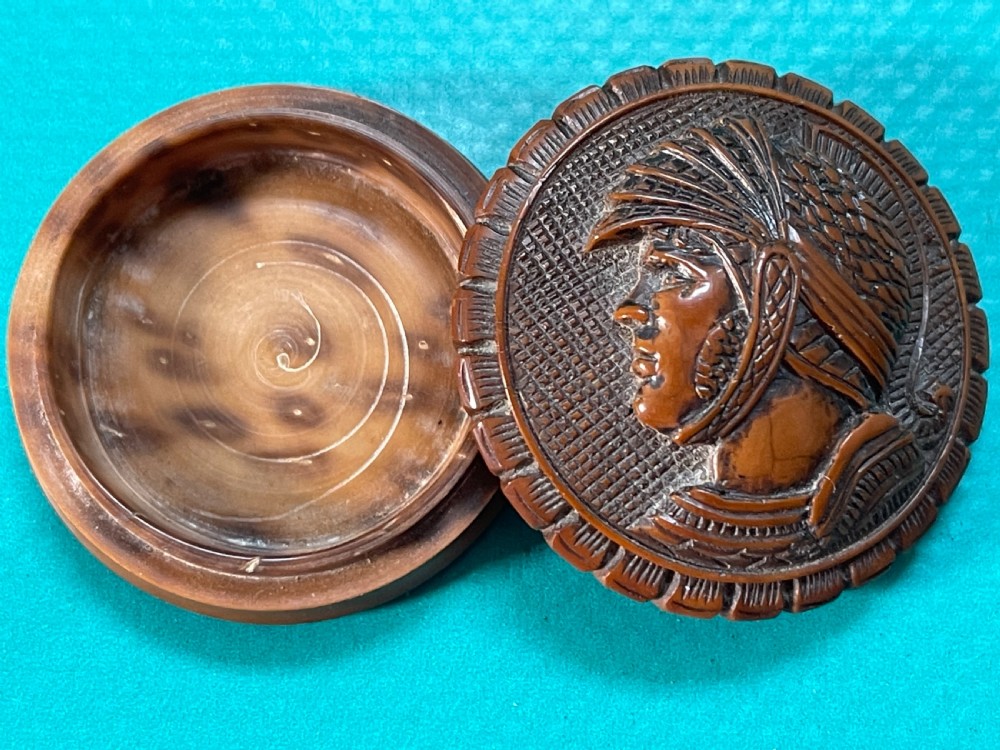 A round Georgian coquilla nut box with a hand-carved classical warrior profile in relief on the detachable lid.