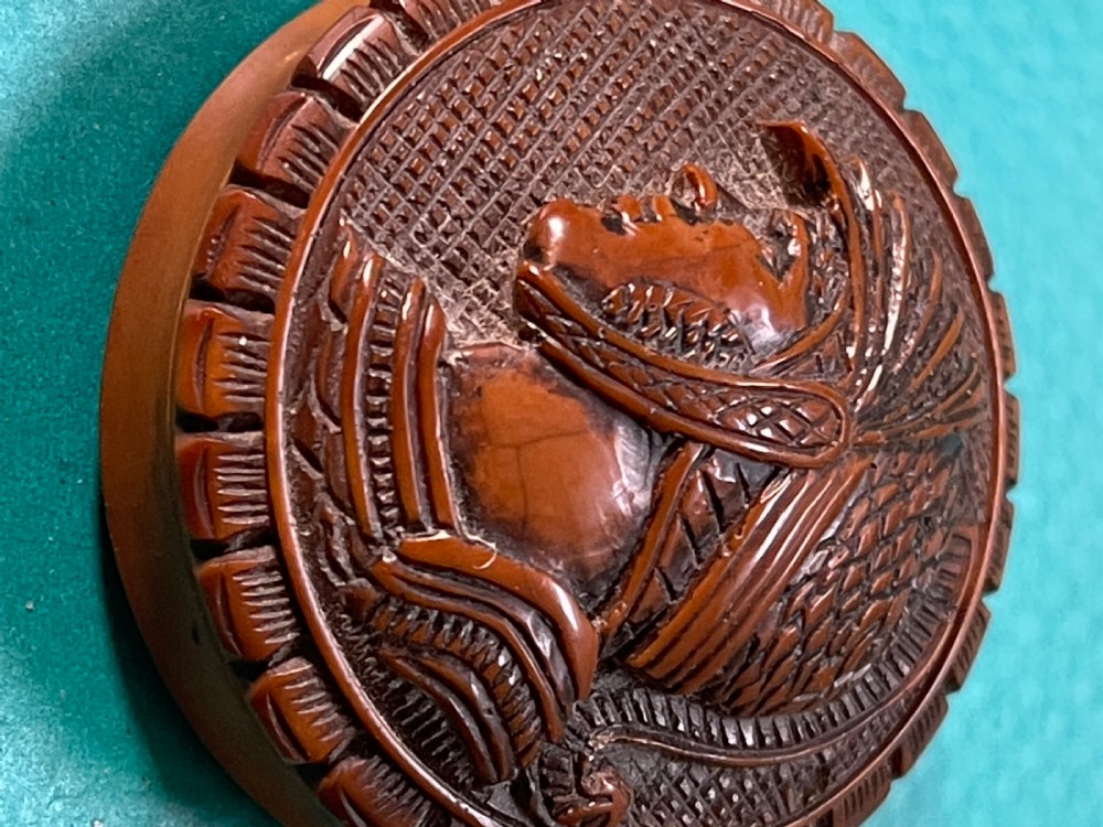 A round Georgian coquilla nut box with a hand-carved classical warrior profile in relief on the detachable lid. View II