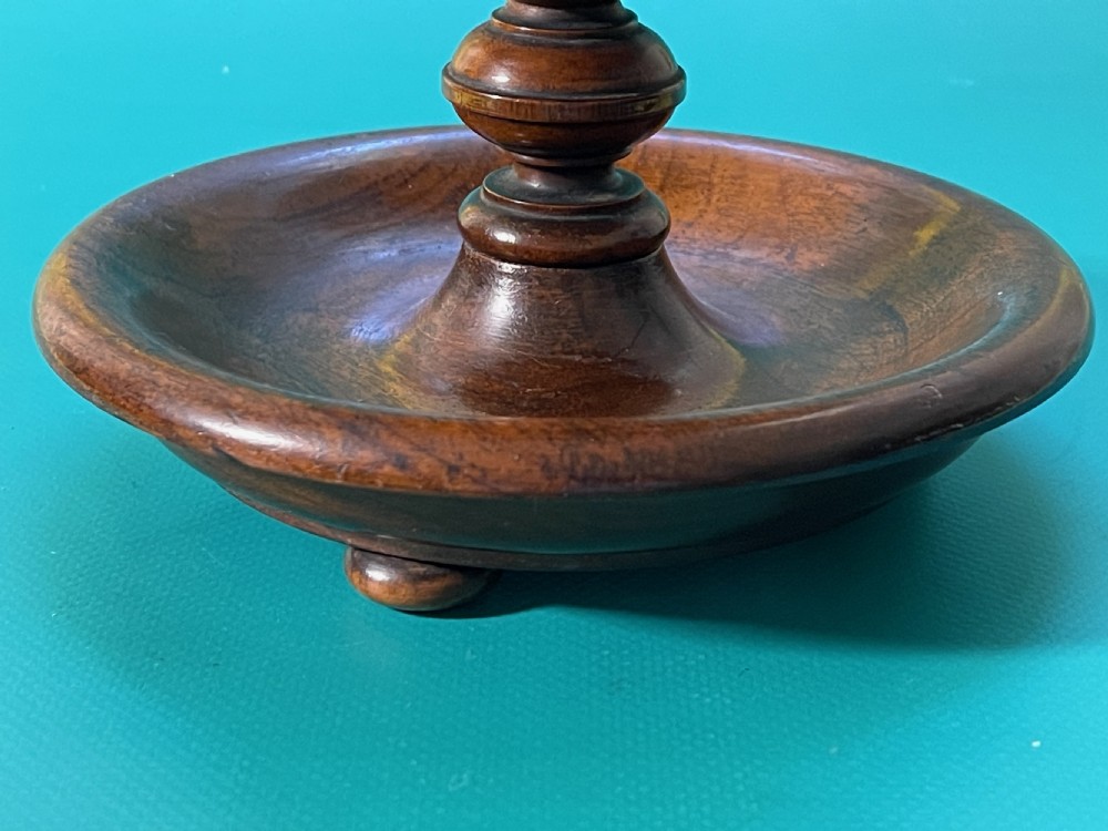 A turned dark wood antique sewing reel stand featuring multiple tiers for thread spools and a cushioned top. View II