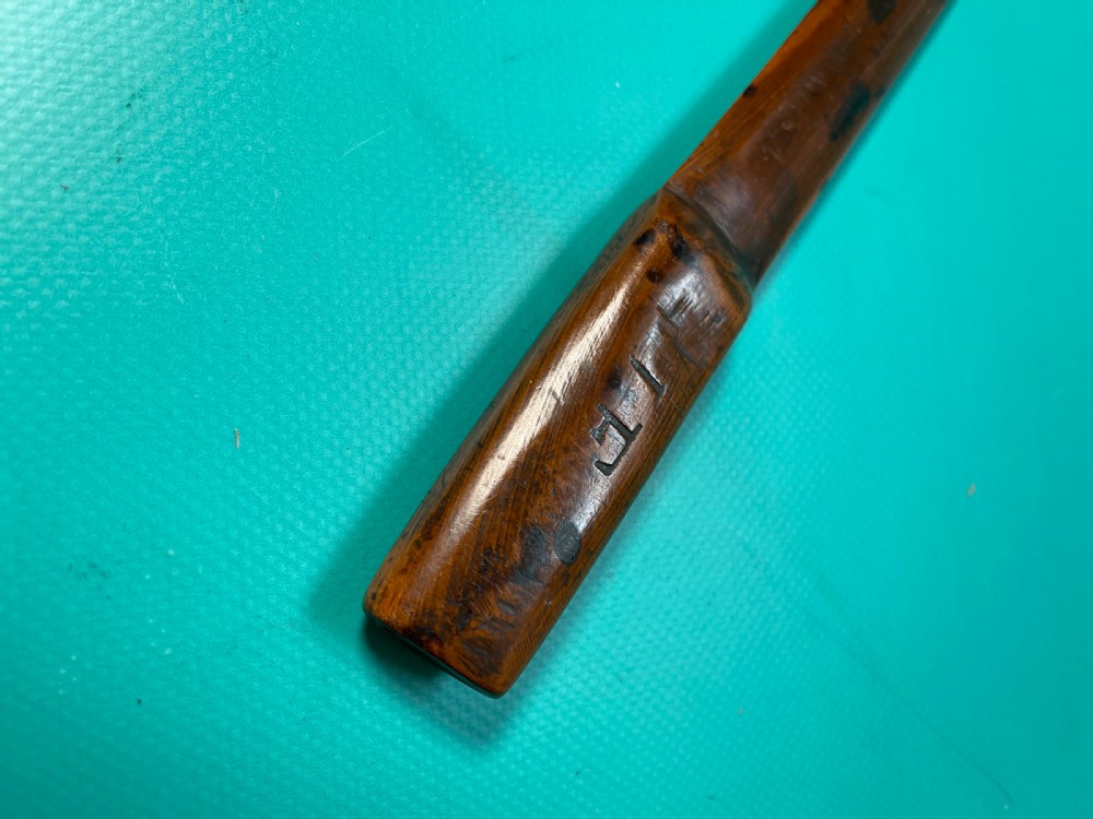 An antique hand-carved yew wood letter opener with a thick rounded handle tapering into a smooth blade. View IX
