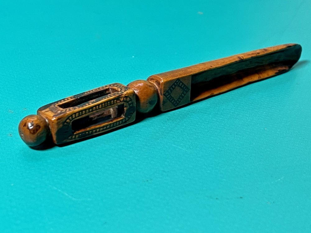 An 18th-century carved fruitwood treen apple corer with geometric incised details and a hollowed scoop. View VIII