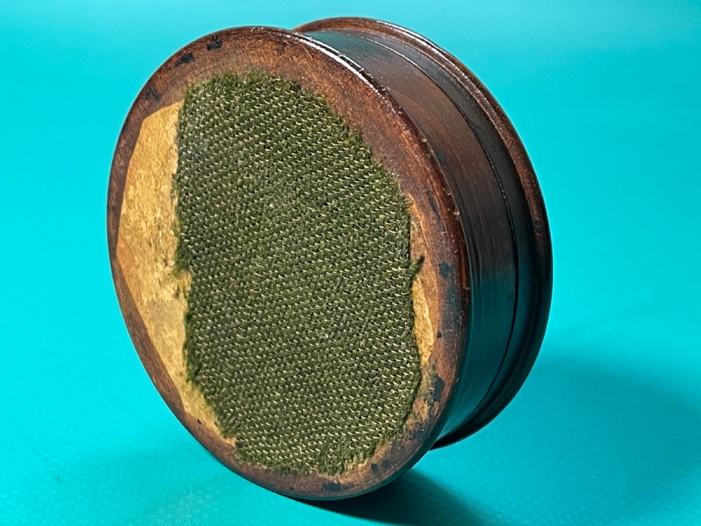 A circular Georgian wooden box featuring dark timber with light wood inlay forming a central rosette, scalloped pattern, and geometric border. View IV