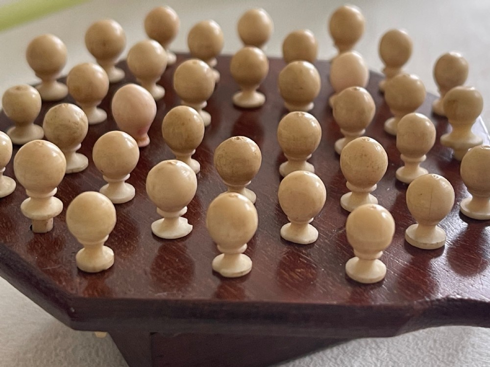 A Mini Sized Peg Solitaire Board & Bone  Pegs View VI