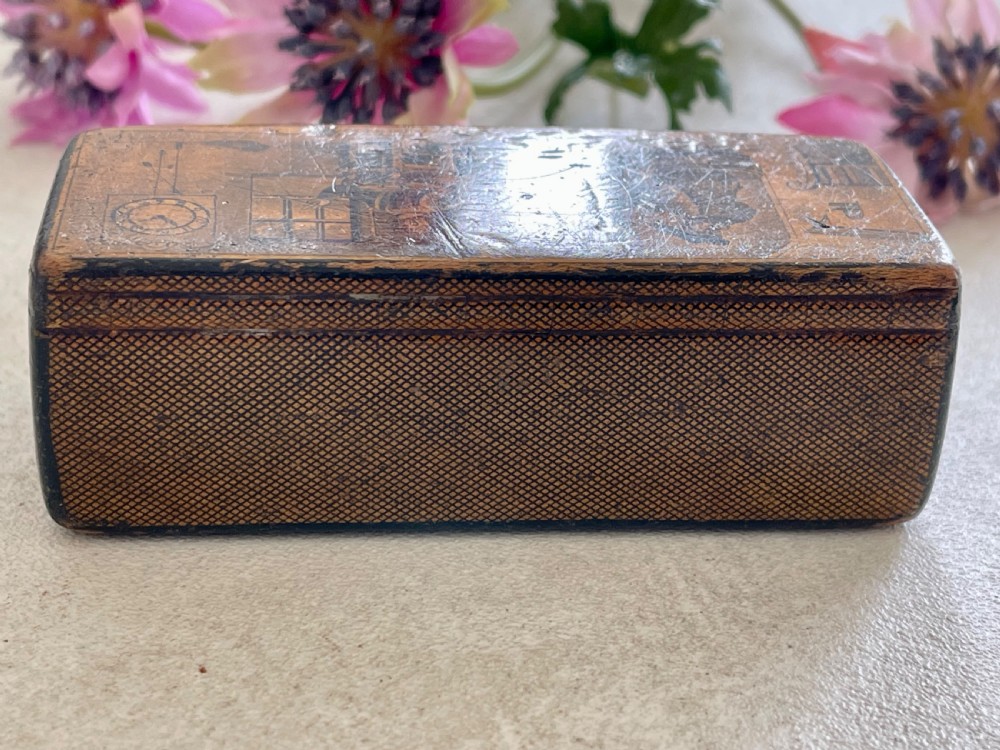 A small rectangular antique wooden snuff box featuring penwork illustrations of men in a tavern on the lid and a central name tag inscribed G. Cobb on the front. View IV