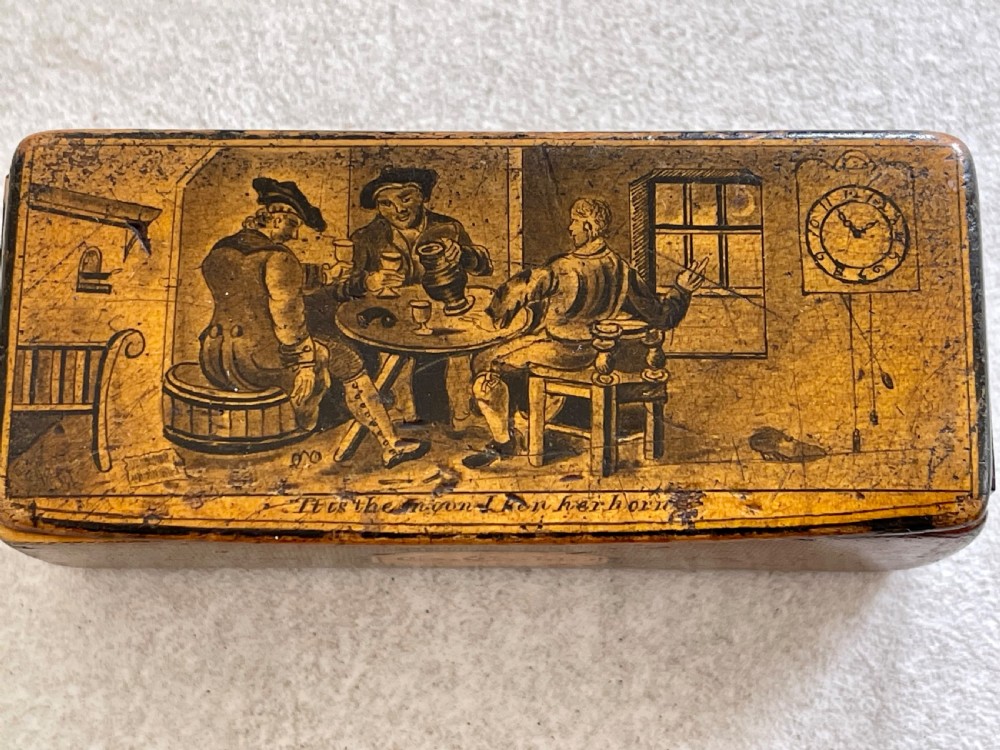 A small rectangular antique wooden snuff box featuring penwork illustrations of men in a tavern on the lid and a central name tag inscribed G. Cobb on the front. View V
