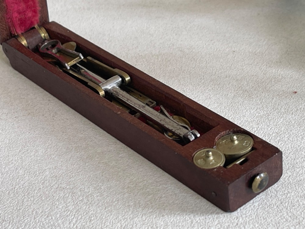 An Antique Coin Scales - with the unusual feature of weights View V