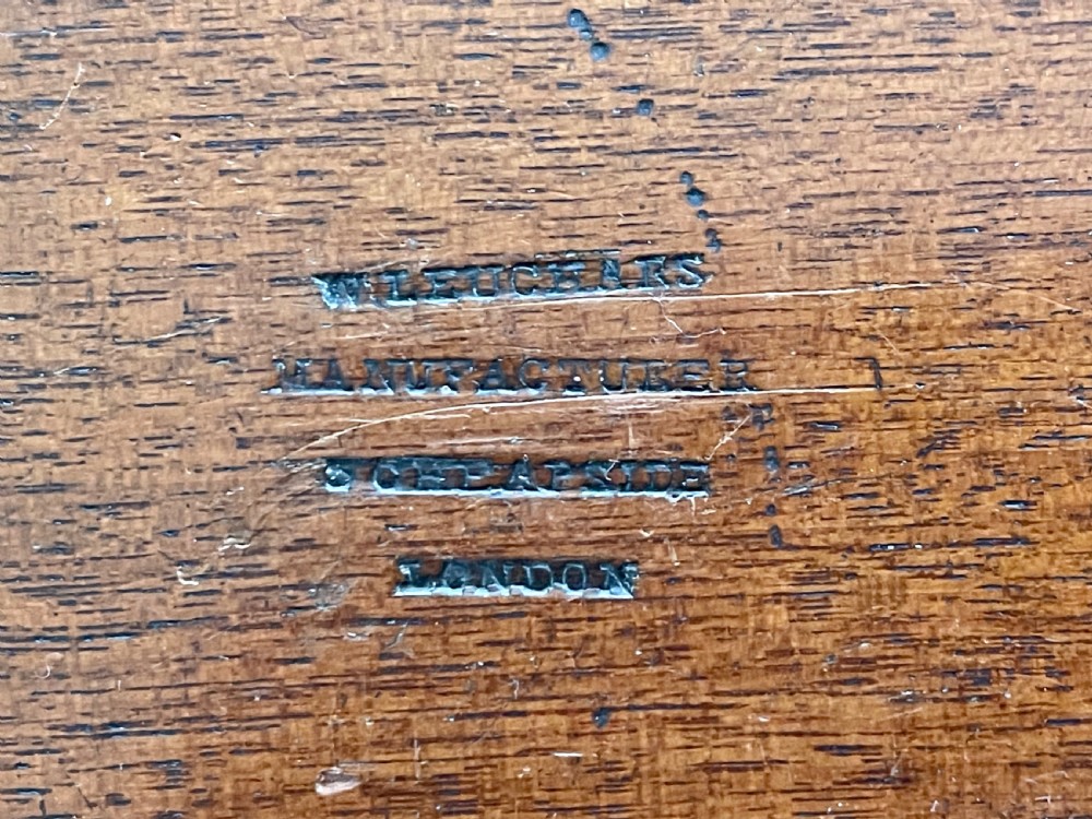 A Victorian mahogany alphabet box shown partially open, revealing a grid of compartments holding bone tiles with printed capital letters. View III