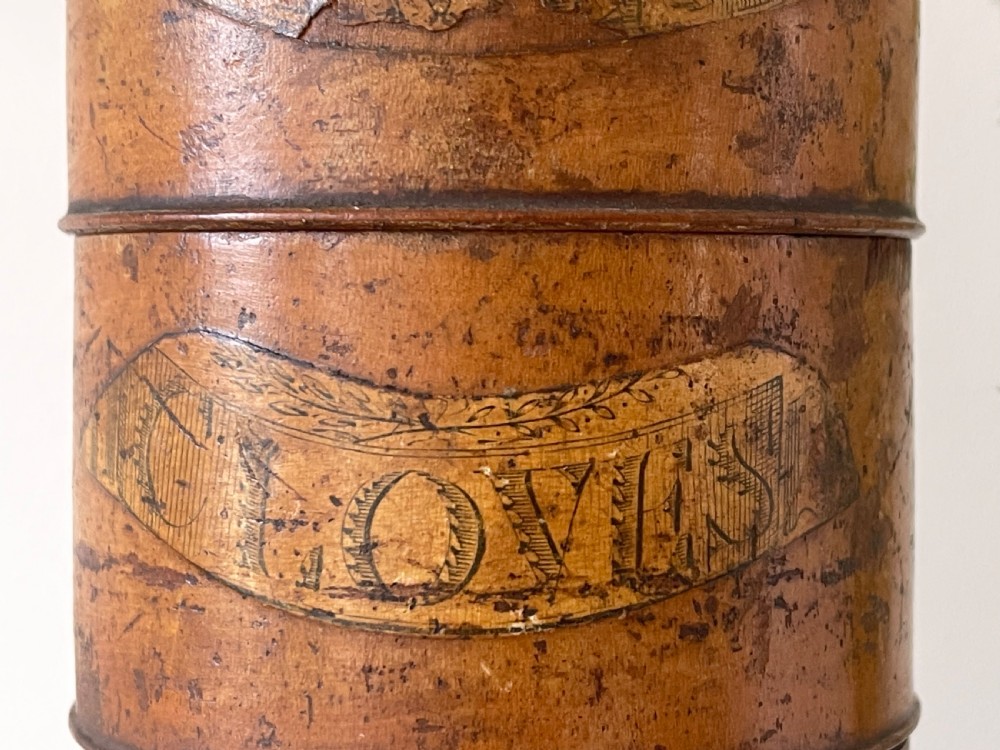 A tall, lathe-turned wooden six-tier cylindrical spice tower featuring original paper labels on each section. View IV