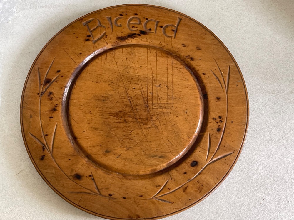 An Antique Treen Bread Board - small size