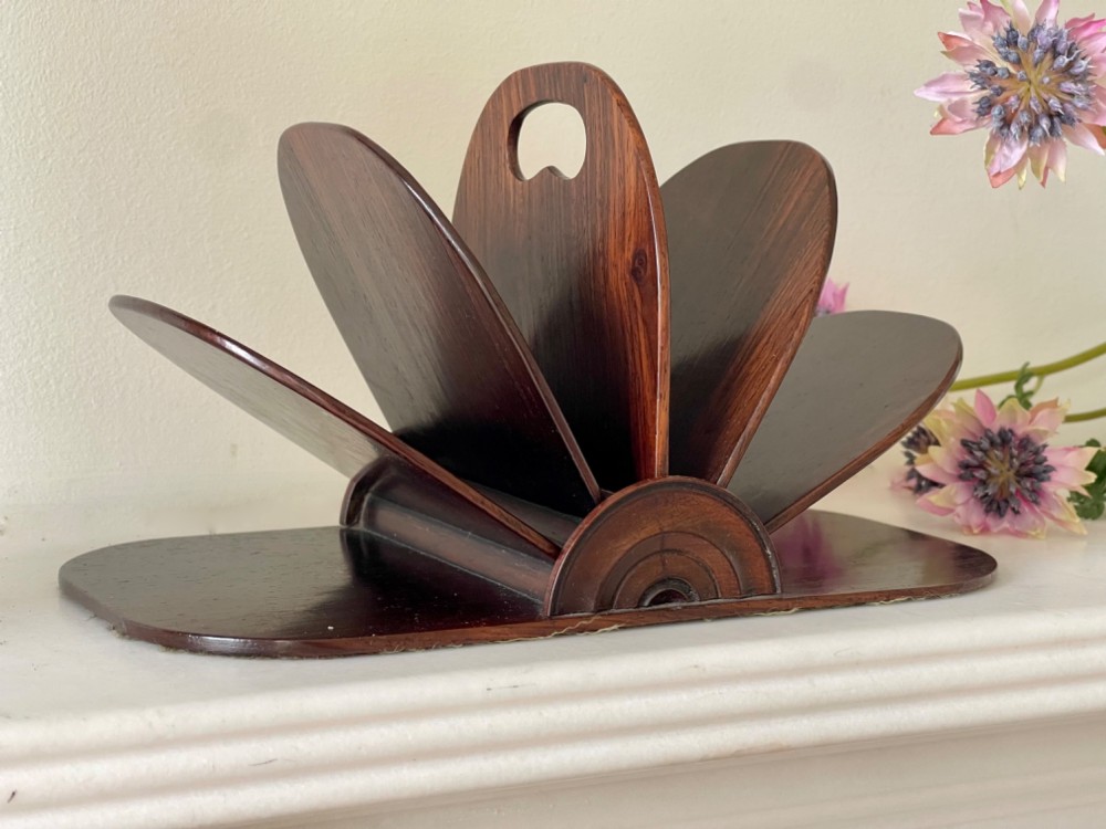 A dark rosewood Regency letter rack featuring a fan-shaped arrangement of tiered dividers mounted on a flat rectangular base with rounded corners.