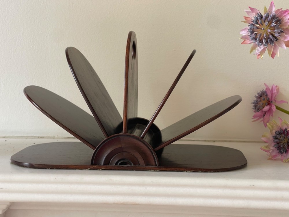 A dark rosewood Regency letter rack featuring a fan-shaped arrangement of tiered dividers mounted on a flat rectangular base with rounded corners. View II