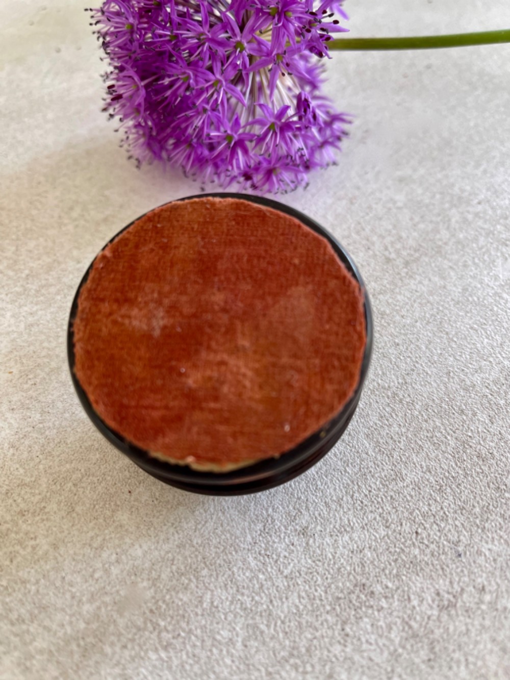 A turned dark lignum vitae wooden case opening to reveal a pocket compass and solar sundial beneath a domed glass lens. View VI