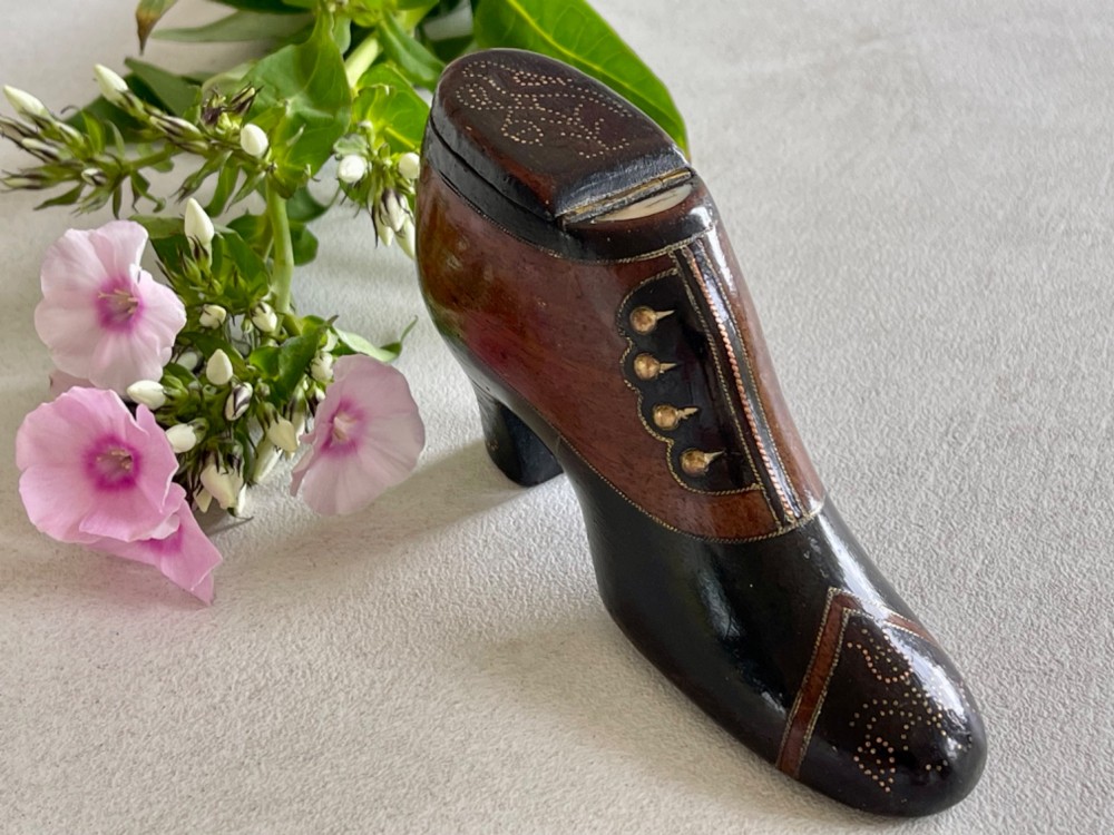 A carved wooden snuff box crafted in the shape of a high-heeled shoe featuring brass pin decoration and double compartments. View IV