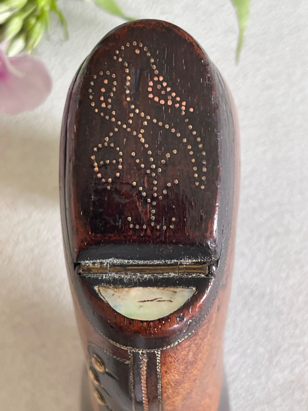 A carved wooden snuff box crafted in the shape of a high-heeled shoe featuring brass pin decoration and double compartments. View VII