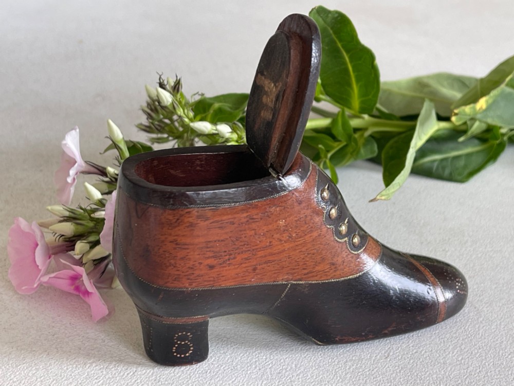 A carved wooden snuff box crafted in the shape of a high-heeled shoe featuring brass pin decoration and double compartments. View VIII