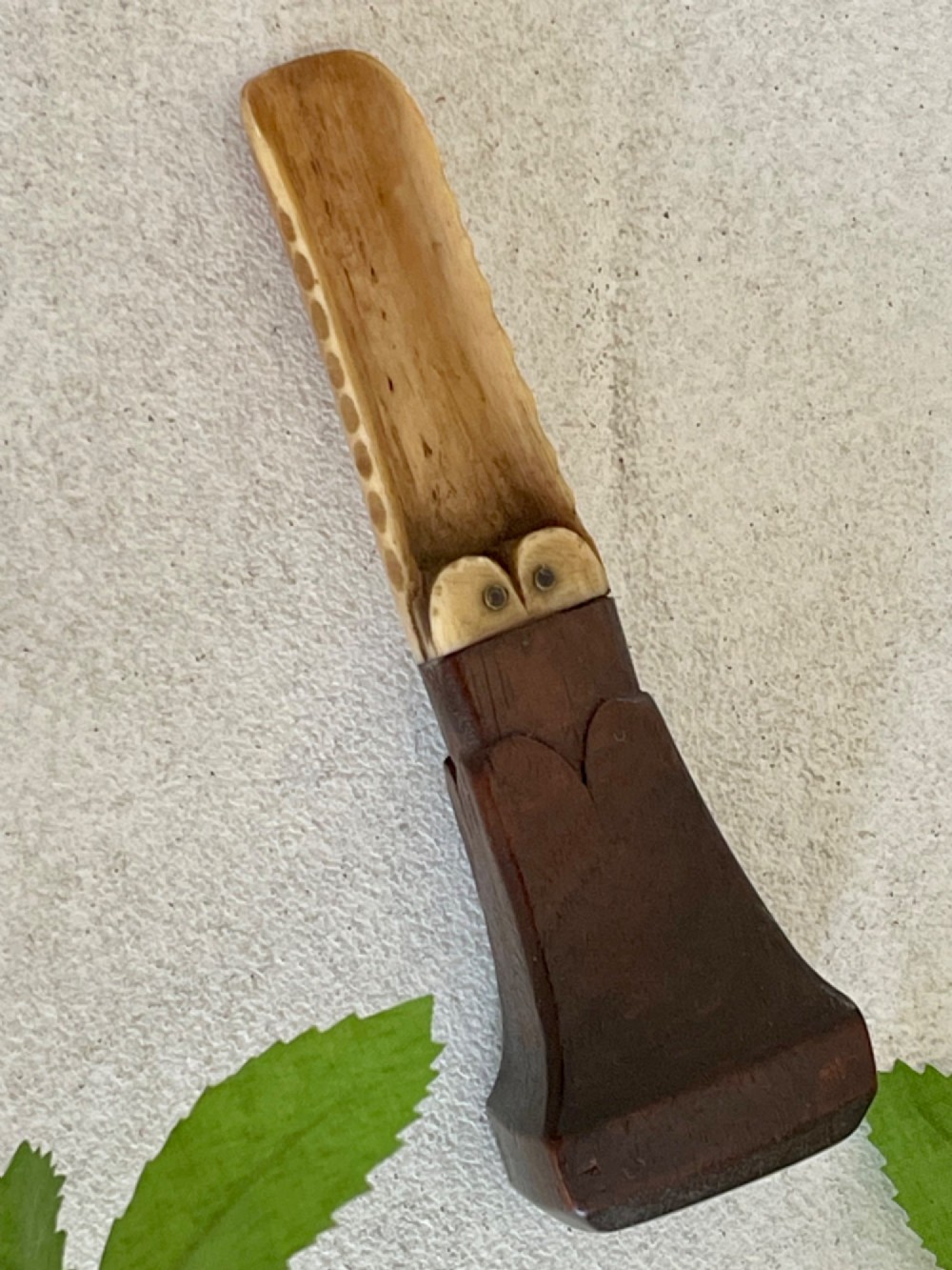 A Georgian treen apple corer featuring a dark mahogany handle joined to a carved bone scoop with metal pins. View IV