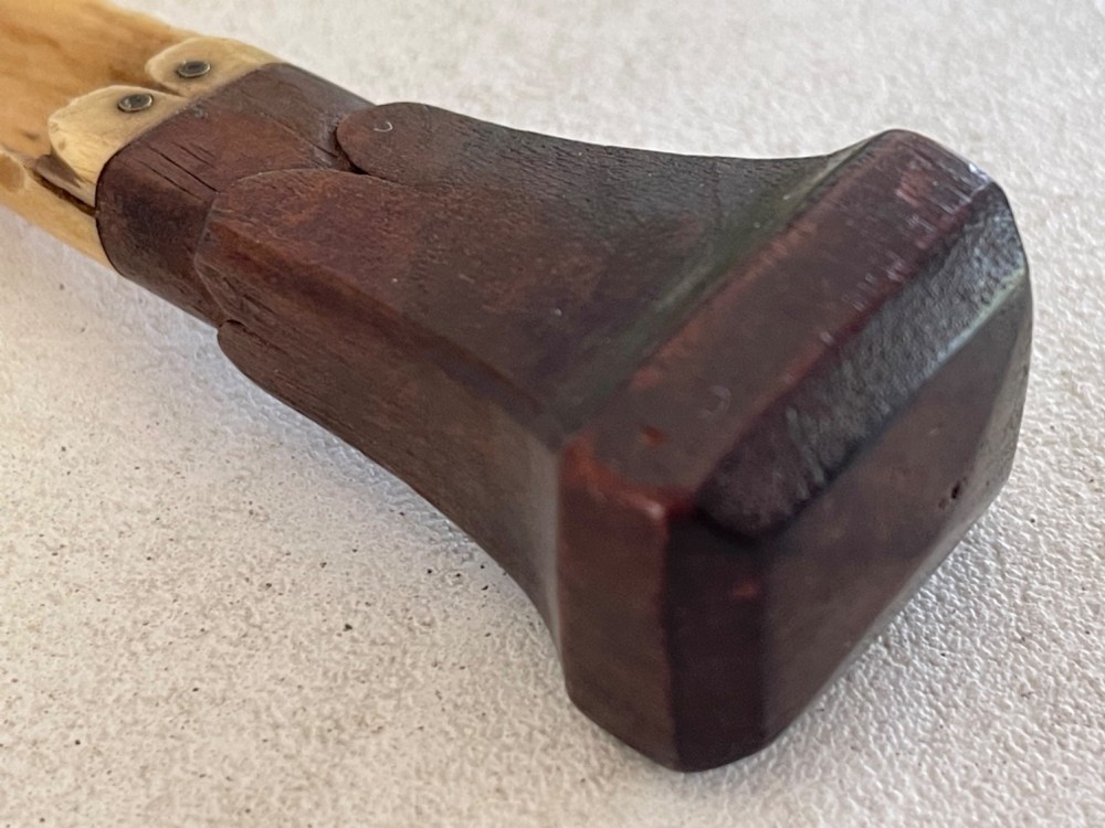 A Georgian treen apple corer featuring a dark mahogany handle joined to a carved bone scoop with metal pins. View VI
