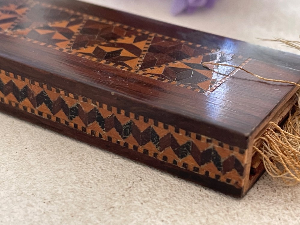A long rectangular dark rosewood silk skein holder featuring a central band of intricate geometric tessellated wood inlay. View II