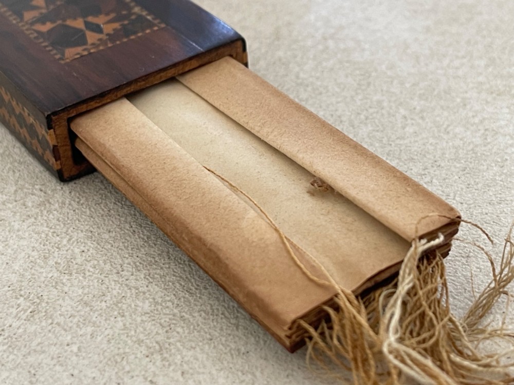 A long rectangular dark rosewood silk skein holder featuring a central band of intricate geometric tessellated wood inlay. View VII