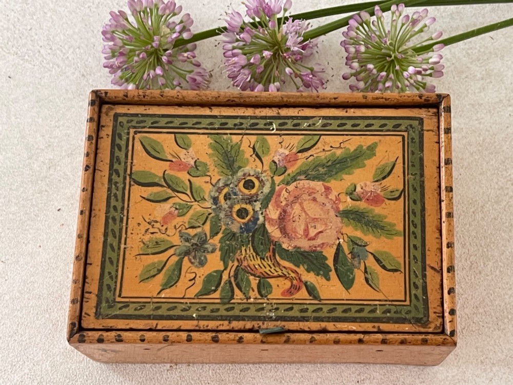 An antique Georgian wooden reel box painted in warm ochre with a floral motif on the lid and thread apertures along the front. View III