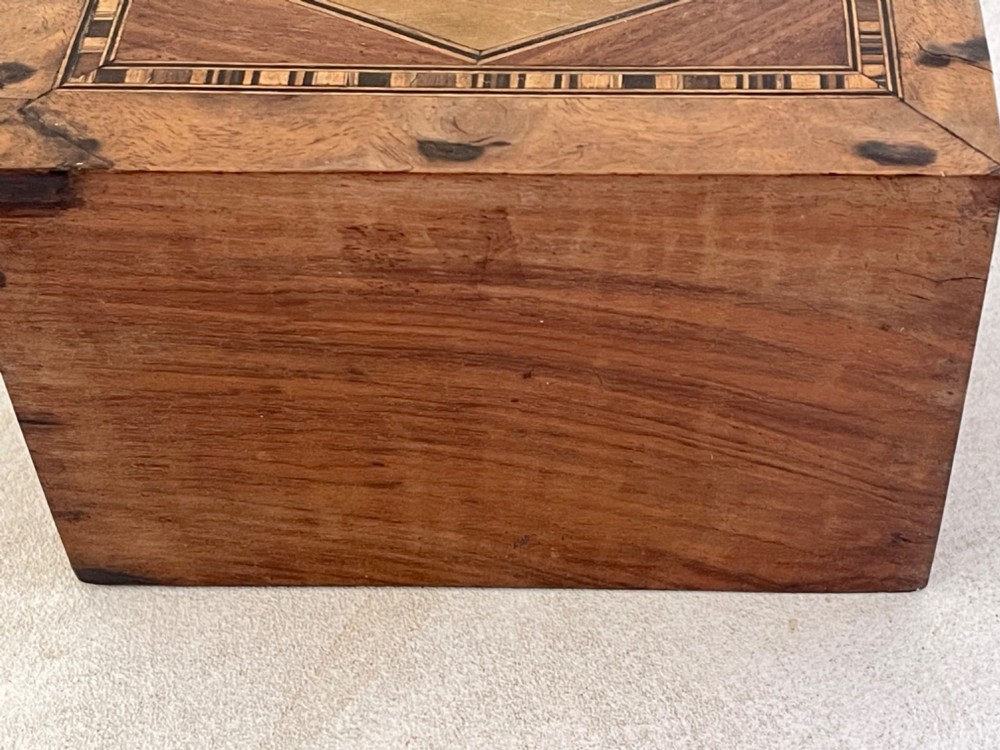 A rectangular mahogany money box featuring an inlaid wooden marquetry panel depicting a steamship at sea alongside a lighthouse. View VIII