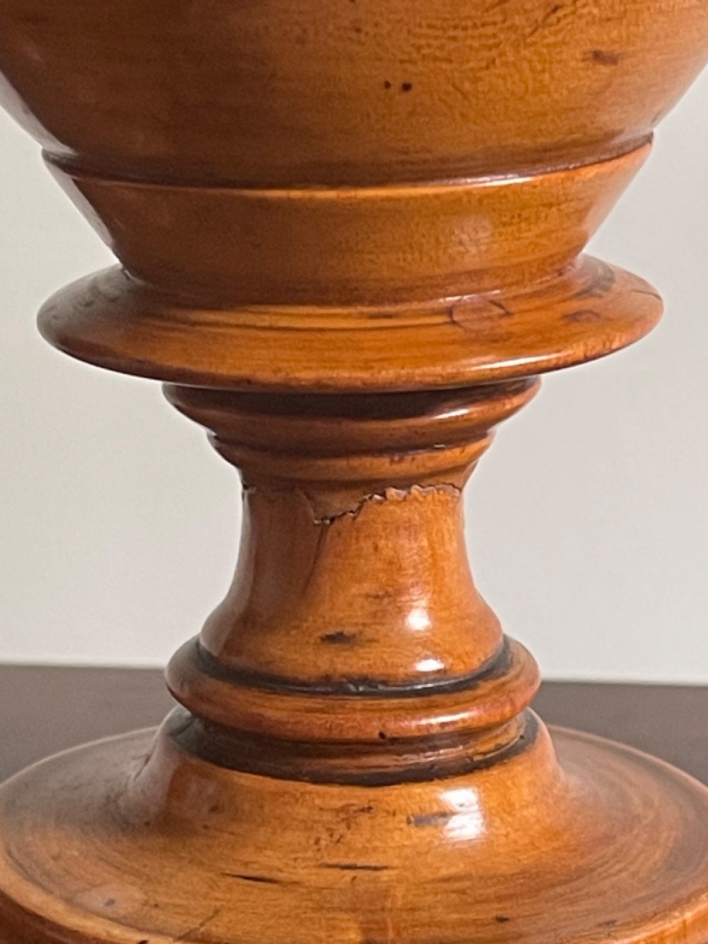 A pair of turned fruitwood goblets featuring knopped stems and stepped circular bases set against a plain background. View II