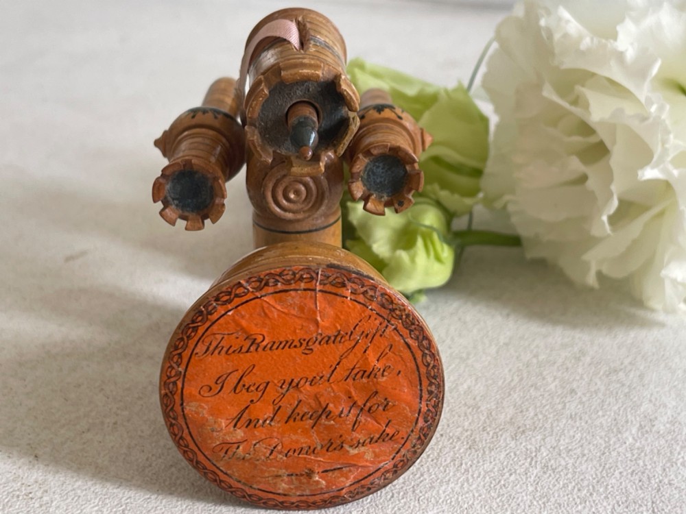 A Georgian turned wood sewing clamp featuring an upper pincushion cup, threaded wooden clamp mechanism, painted line decoration, and matching wooden needle cases. View III