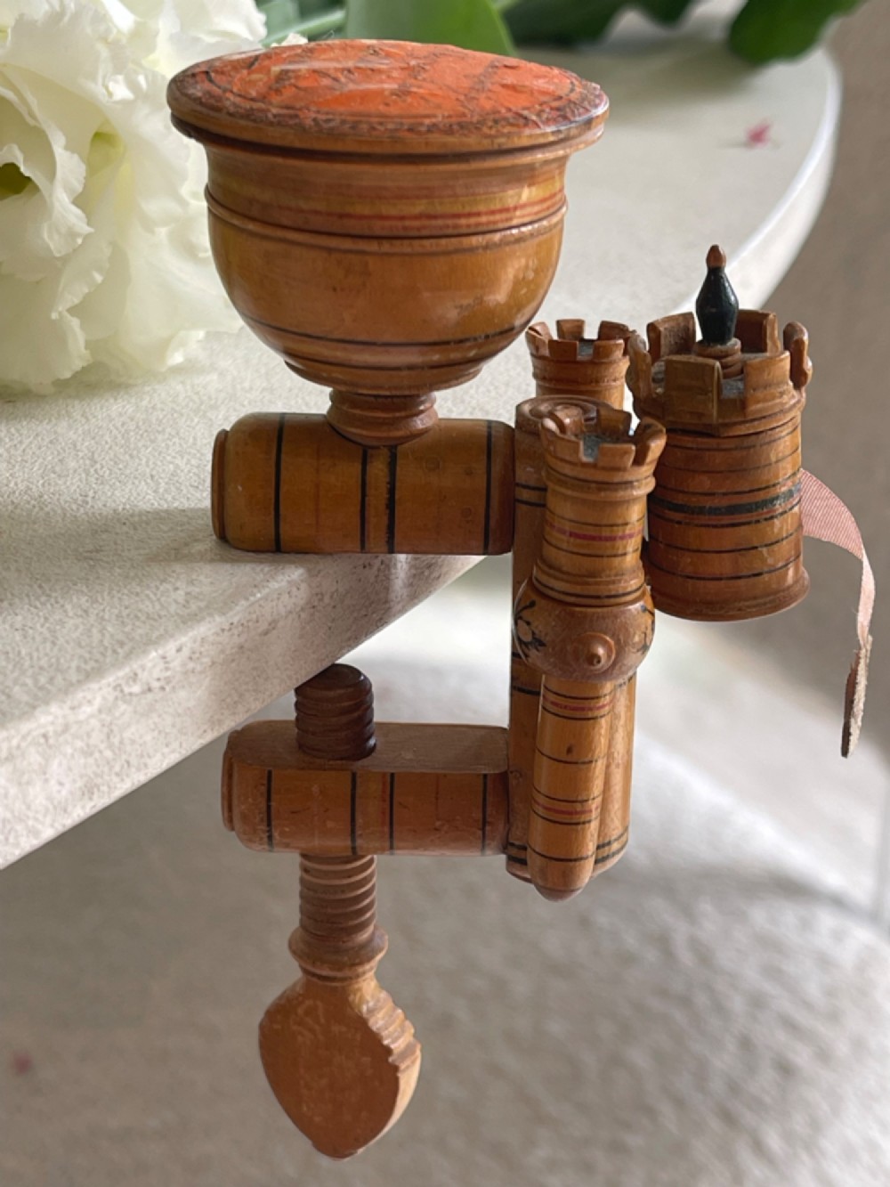 A Georgian turned wood sewing clamp featuring an upper pincushion cup, threaded wooden clamp mechanism, painted line decoration, and matching wooden needle cases. View IV