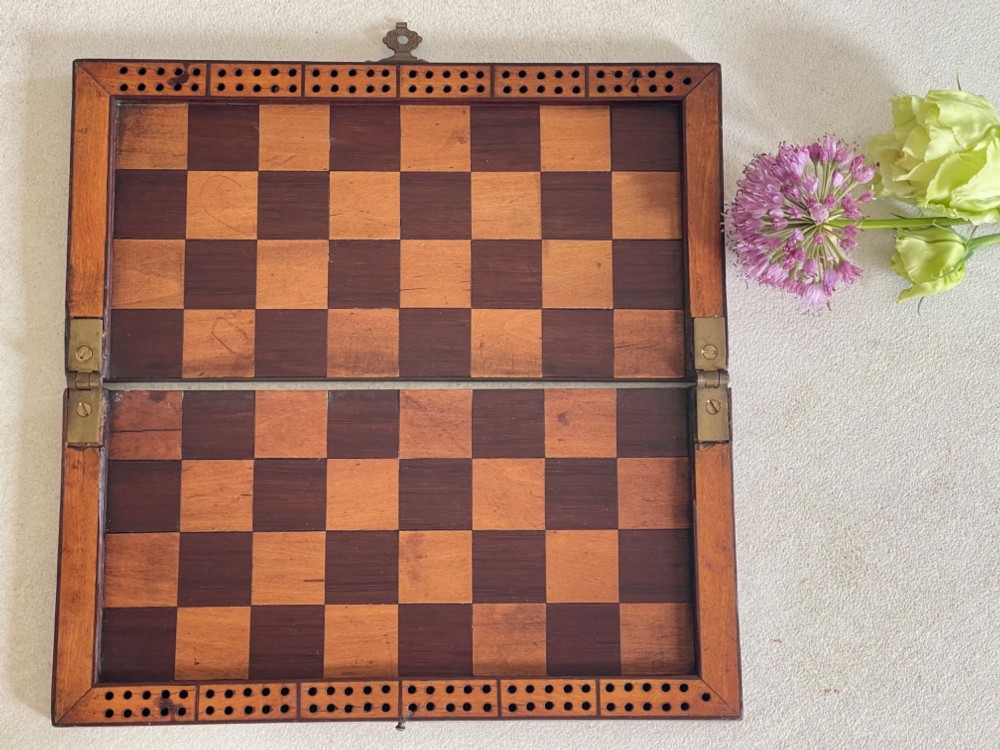A rectangular Georgian folding wooden games board featuring central oval shell marquetry inlay, crossbanded borders, and a brass latch on the side. View IV