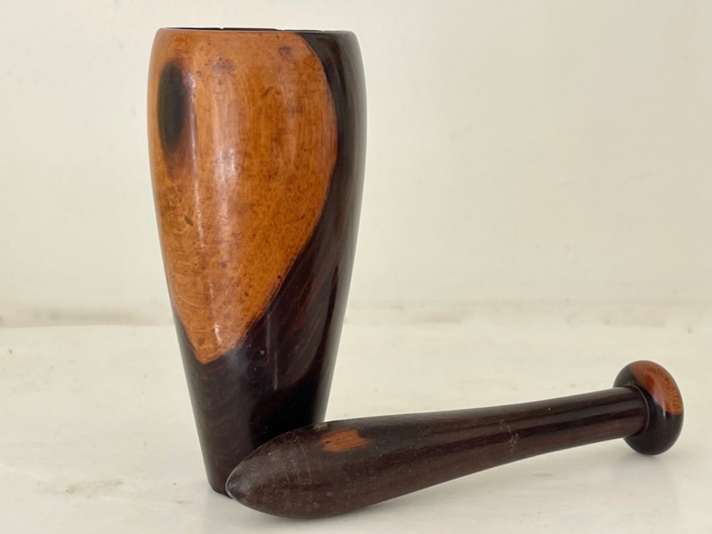 A hand-turned wooden snuff mortar and pestle crafted from contrasting dark and light grain hardwood. View III