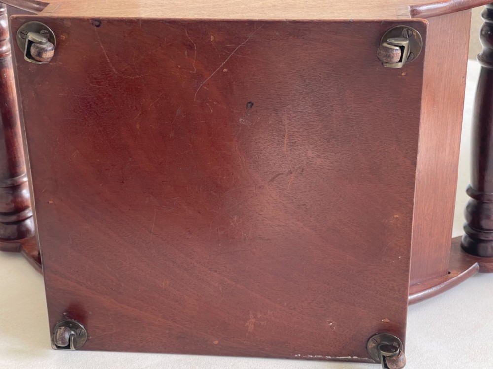 A curved Georgian mahogany cheese coaster with turned end handles and small brass castors on the base. View II
