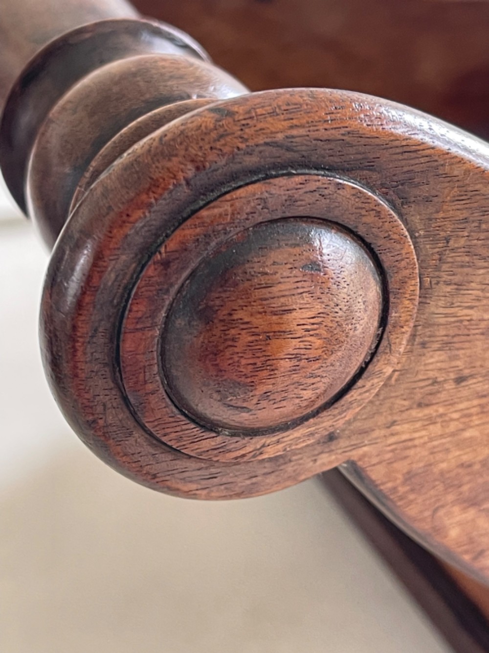 A curved Georgian mahogany cheese coaster with turned end handles and small brass castors on the base. View III