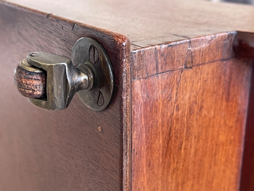 A curved Georgian mahogany cheese coaster with turned end handles and small brass castors on the base. View XI