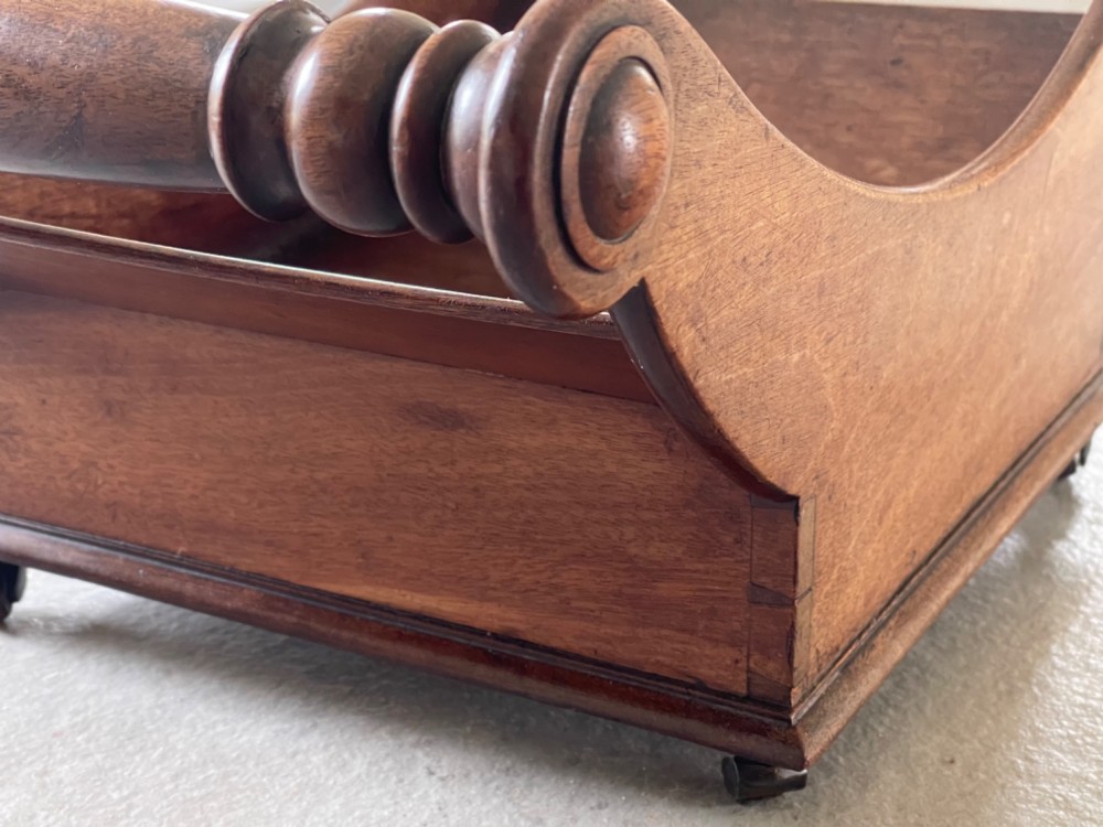 A curved Georgian mahogany cheese coaster with turned end handles and small brass castors on the base. View XII
