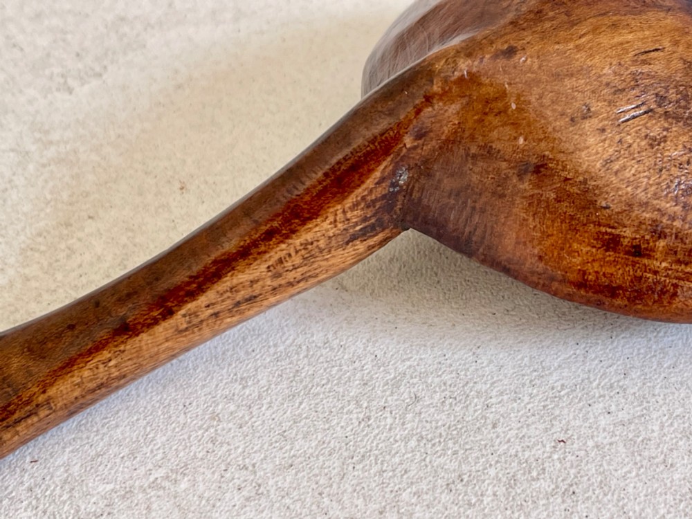 A hand-carved antique treen wooden ladle featuring a deep circular bowl and a shaped handle with decorative notched detailing. View III