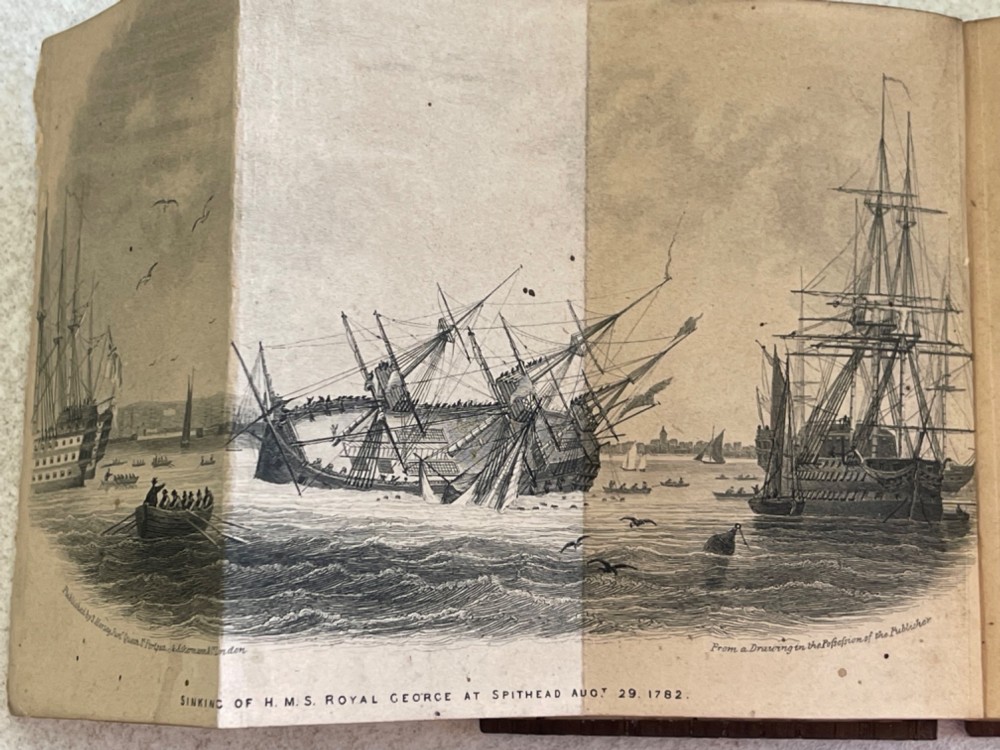 An antique small volume bound with dark wooden board covers, a worn red spine with gilt lettering, and internal pages with printed maritime engravings. View V