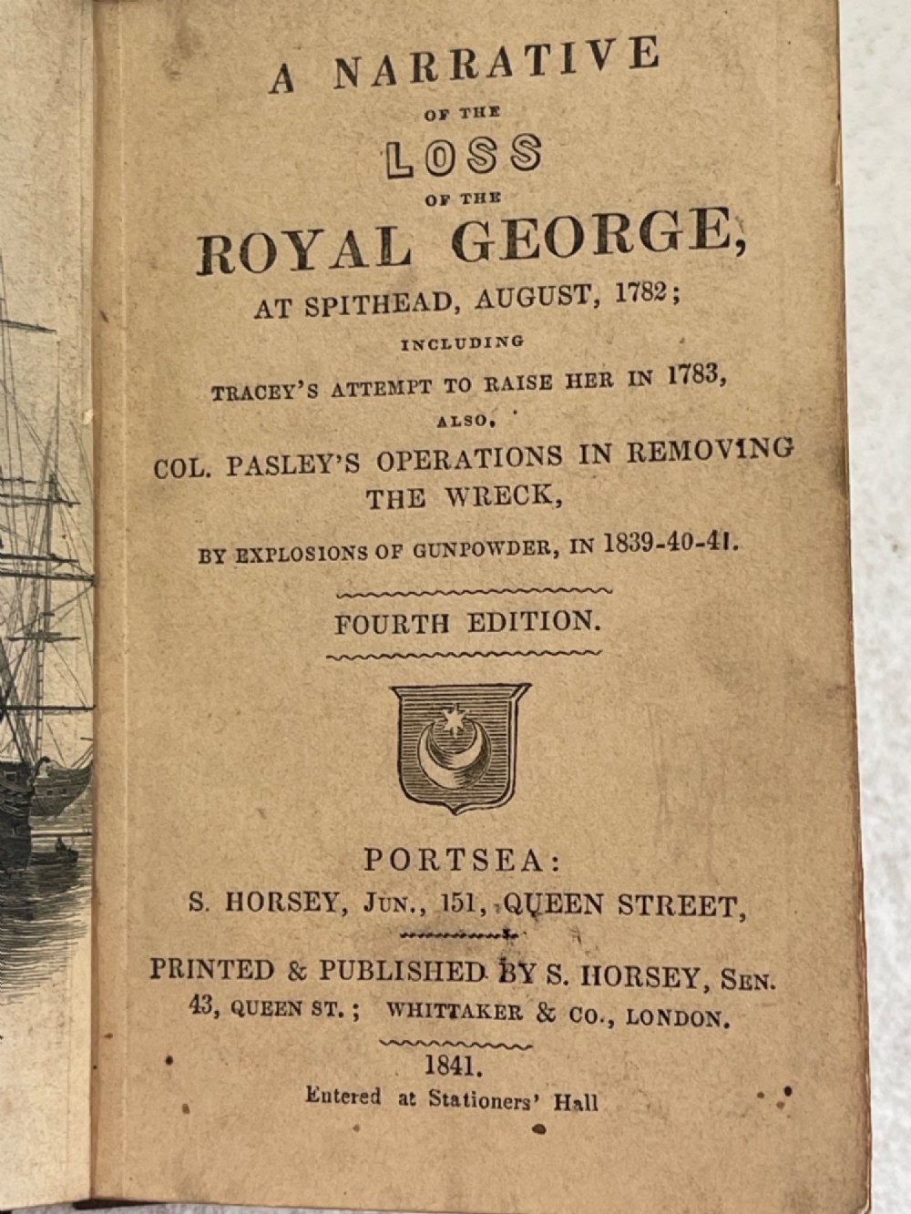 An antique small volume bound with dark wooden board covers, a worn red spine with gilt lettering, and internal pages with printed maritime engravings. View VIII
