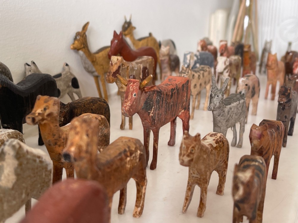 A hand-painted 19th-century wooden Noahs ark toy with a pitched roof and painted windows, accompanied by carved wooden figures. View III