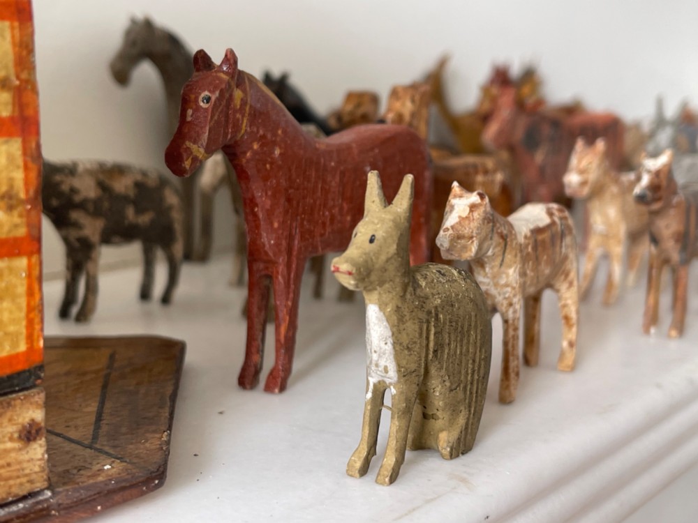 A hand-painted 19th-century wooden Noahs ark toy with a pitched roof and painted windows, accompanied by carved wooden figures. View IV