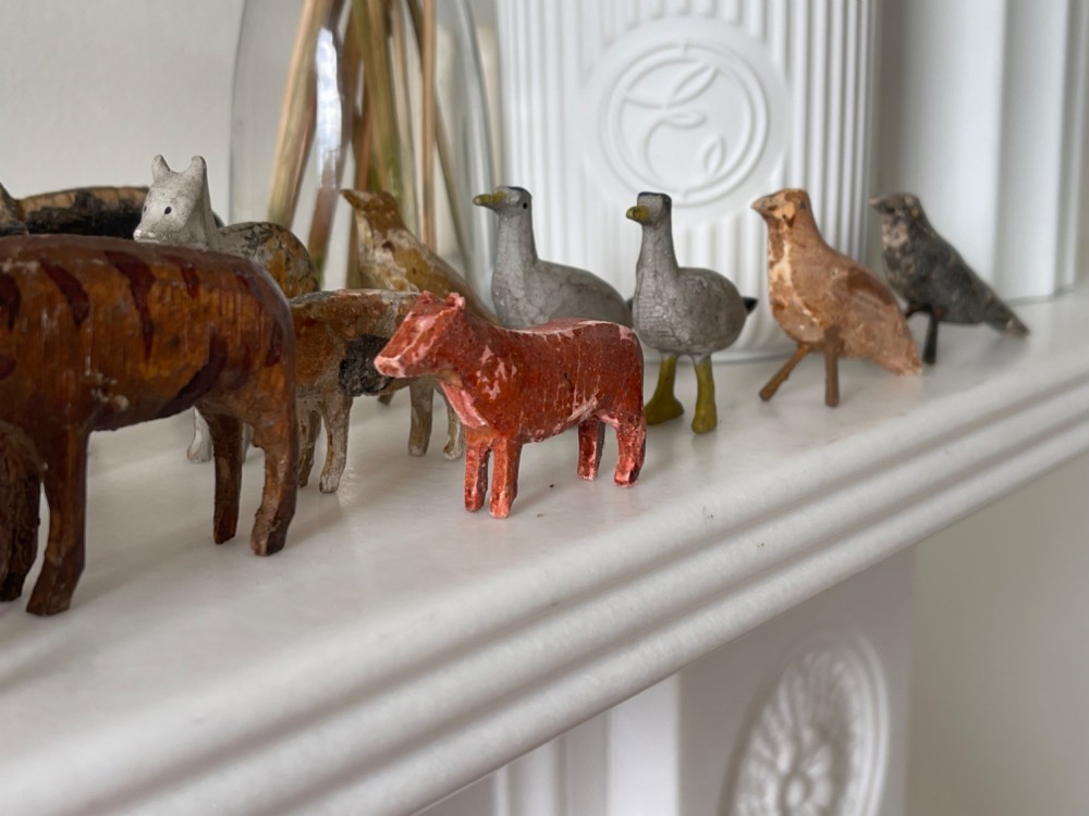 A hand-painted 19th-century wooden Noahs ark toy with a pitched roof and painted windows, accompanied by carved wooden figures. View VII
