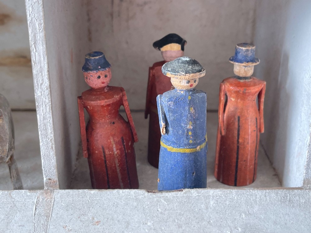 A hand-painted 19th-century wooden Noahs ark toy with a pitched roof and painted windows, accompanied by carved wooden figures. View X