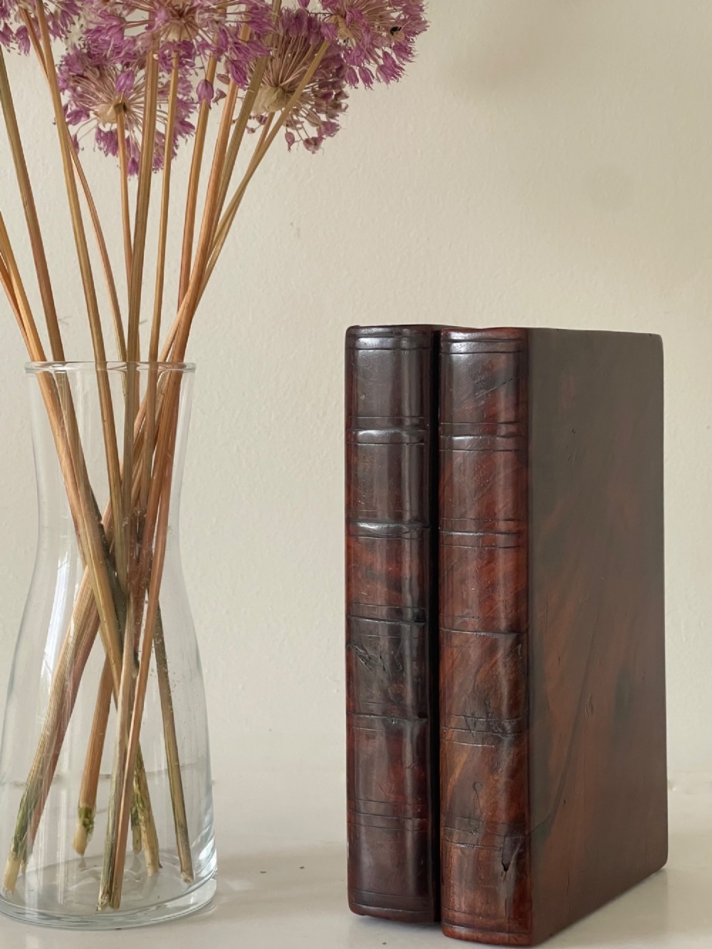 An antique dark polished wood box carved in the shape of two vertical book spines.