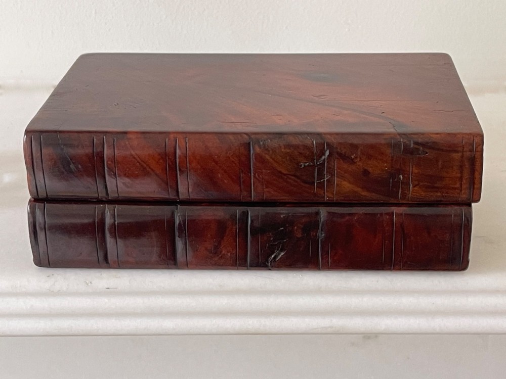 An antique dark polished wood box carved in the shape of two vertical book spines. View II